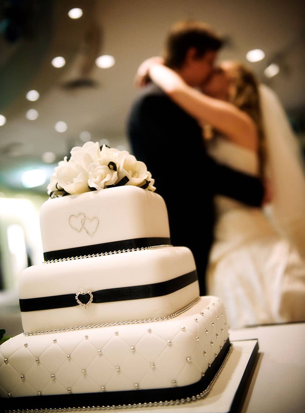 Classic black and white wedding cake with ribbon and diamonte details