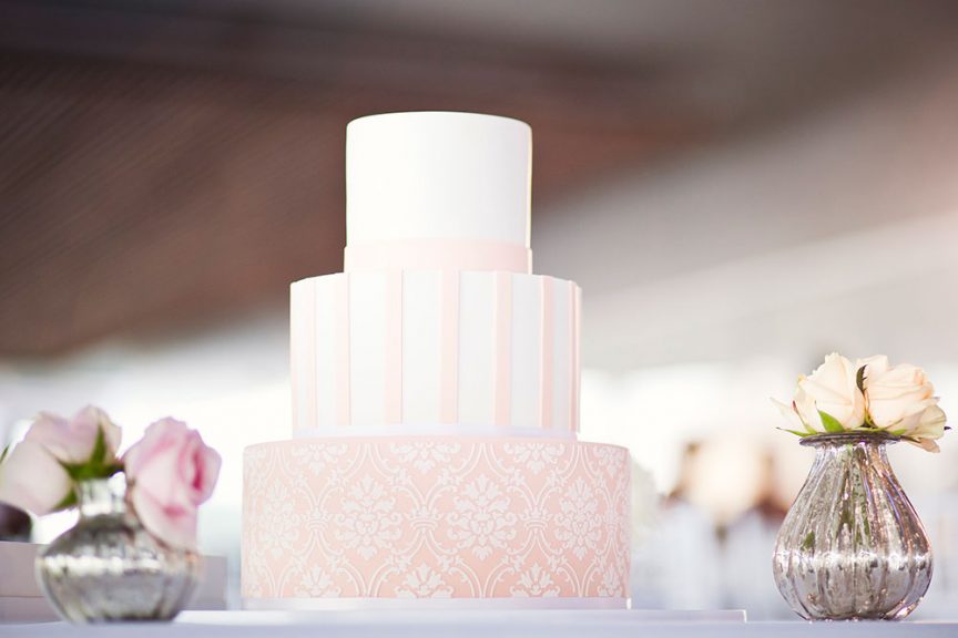 3-tier pink and white wedding cake with lace detail. Photo: Studio Impressions