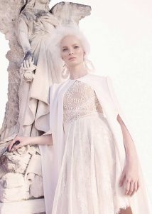 The "Apollo" short lace wedding dress and matching cape from the George Wu Sancta Sedes 2016 collection.