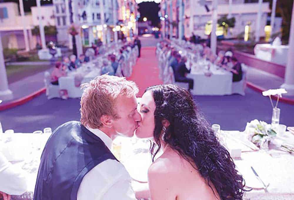 Bride and groom sharing a kiss at their Movie World reception