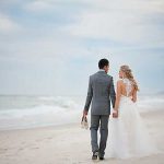 Bride and groom for their beach wedding in winter