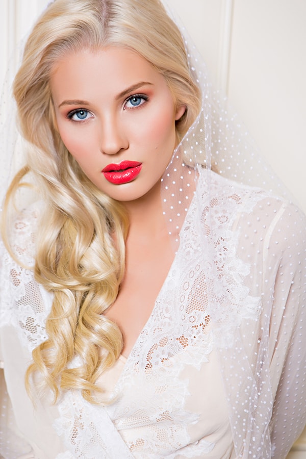 Glam bridal beauty look with bold red lip.