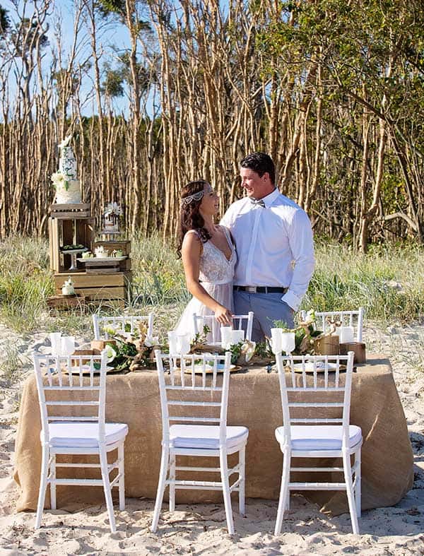 Boho bride and groom on the beach for their reception