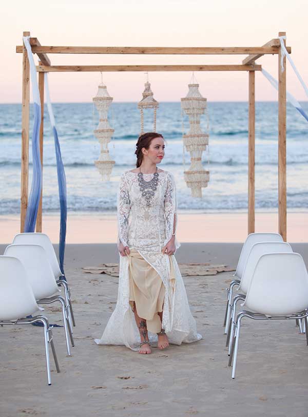 Flowing silks and chandeliers for a tropical beach ceremony