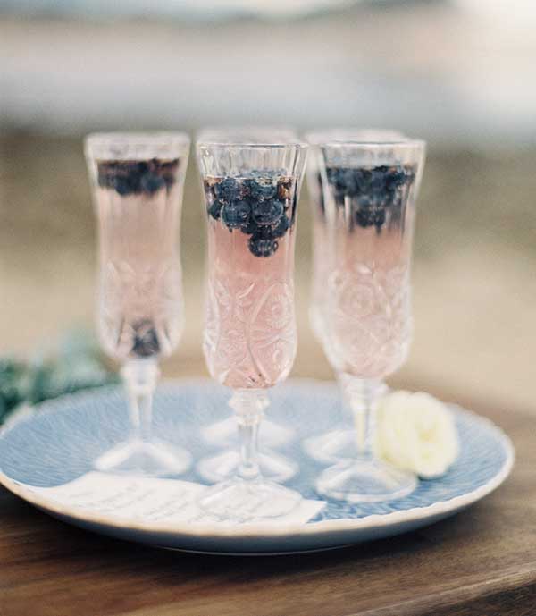 Pastel-coloured aperitifs in pretty vintage flutes are a fave for tropical weddings