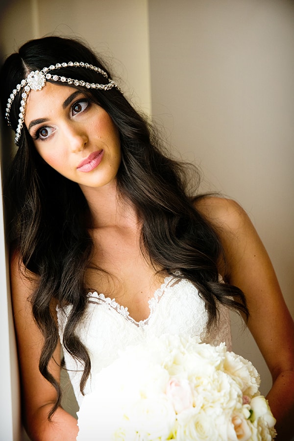 Bride Yiota embraces hair accessories with a boho meets glam bridal look wearing a beaded 1920s headpiece.