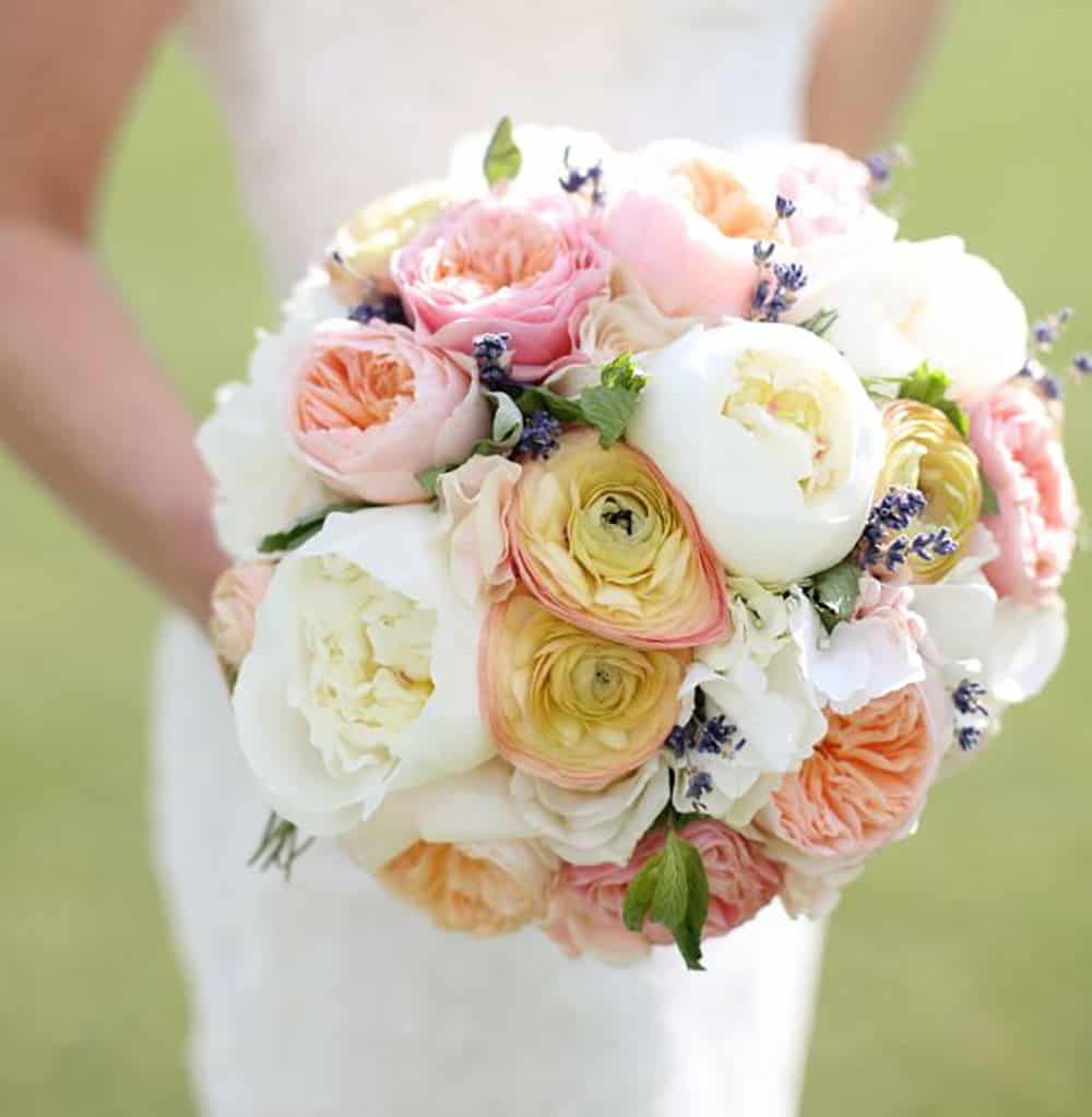 Round bouquet in pink, white and peach hues.