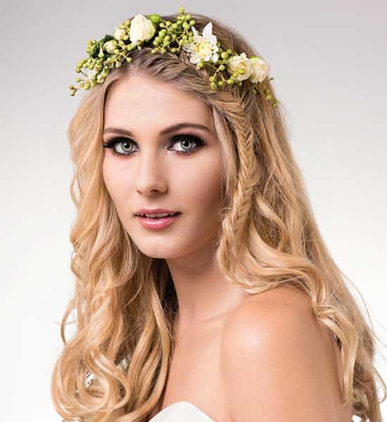 Bride with loose curls and fishtail braid by Evalyn Parsons Hair wearing a native floral crown, Makeup by hair & Makeup by Giulia, wearing a gown from Paddington Weddings.
