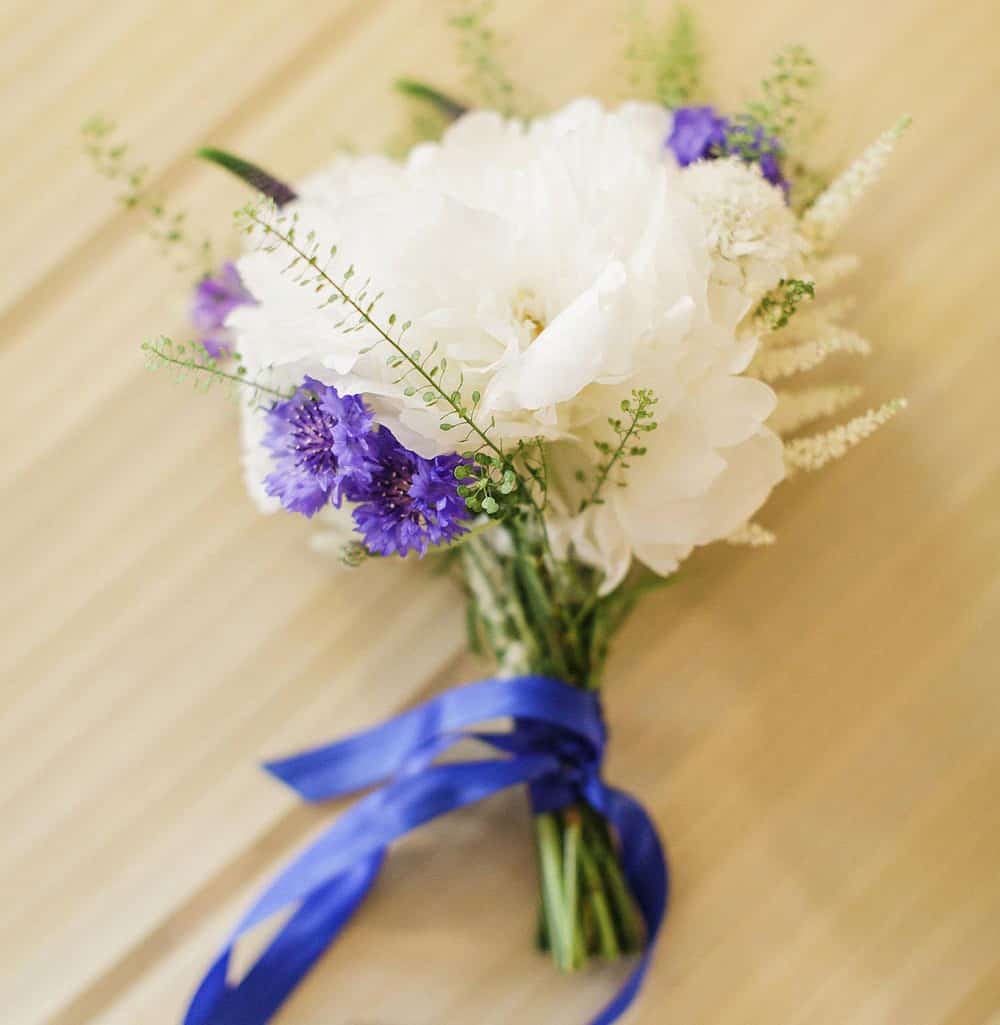 Nosegay bouquet with purple and white florals.