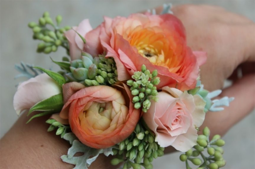 Peach & coral ranunculus wrist corsage with succulents