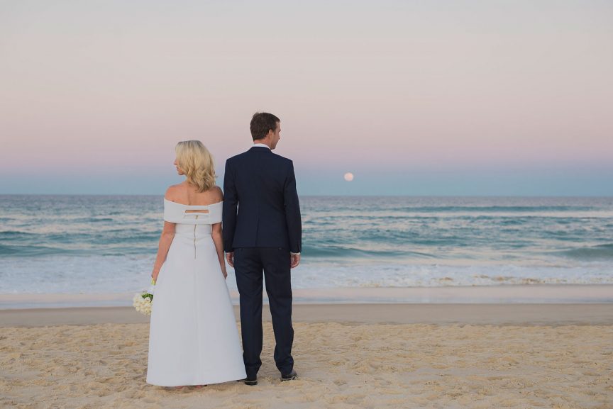 Bride and groom on the beach at sunset