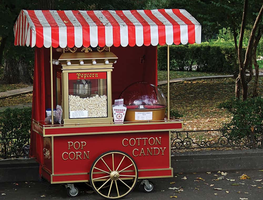 a popcorn and cotton candy food station at a wedding reception