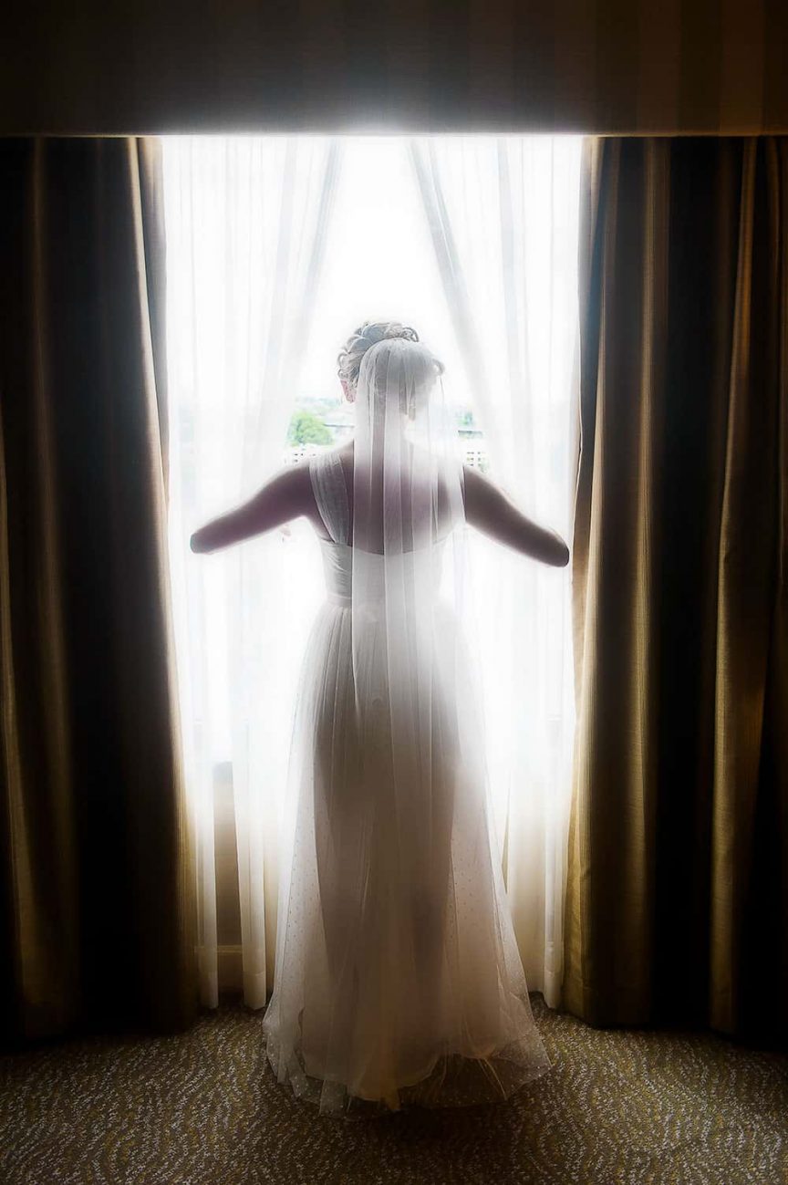 bride looking through window