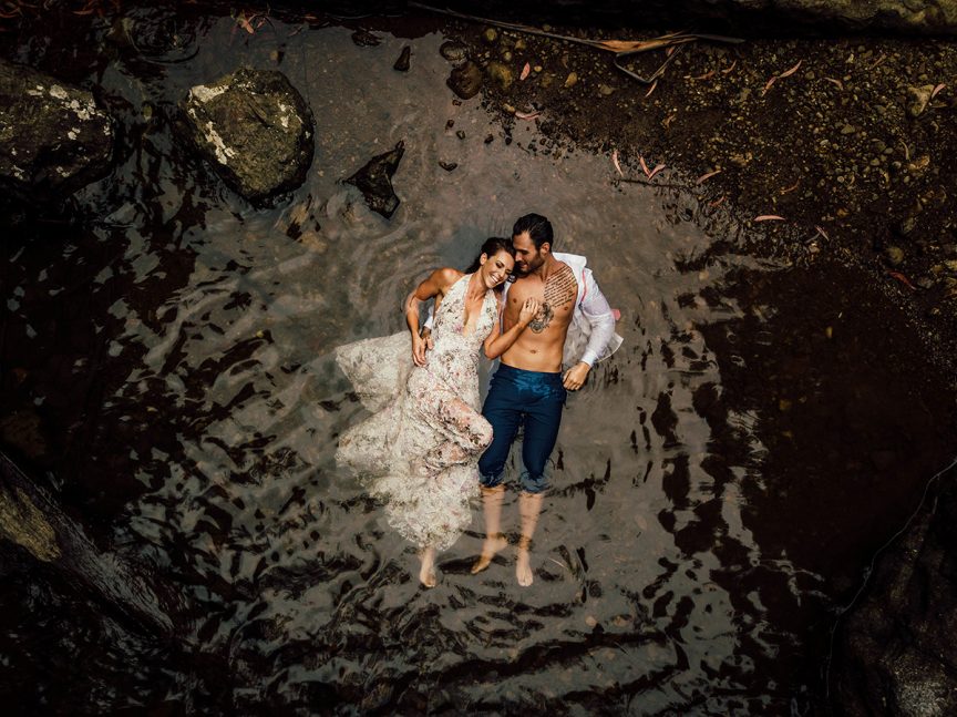 Couple swimming in waterfall