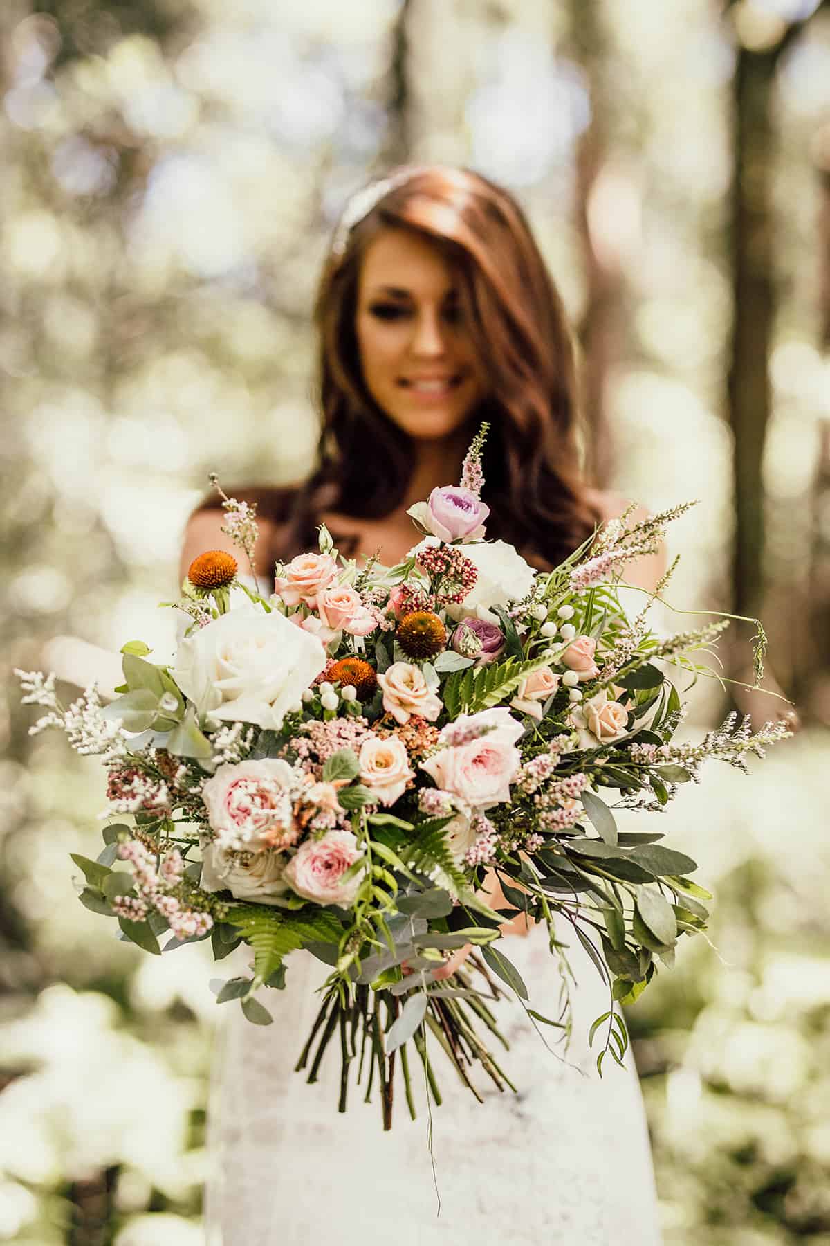 Bride with bouquet in rainforest