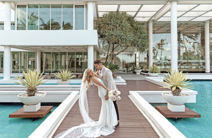Sheraton-Gold-Coast-Weddings-newlywed-newlyweds-newlywedded-couple-on-a-walkway-by-the-pool