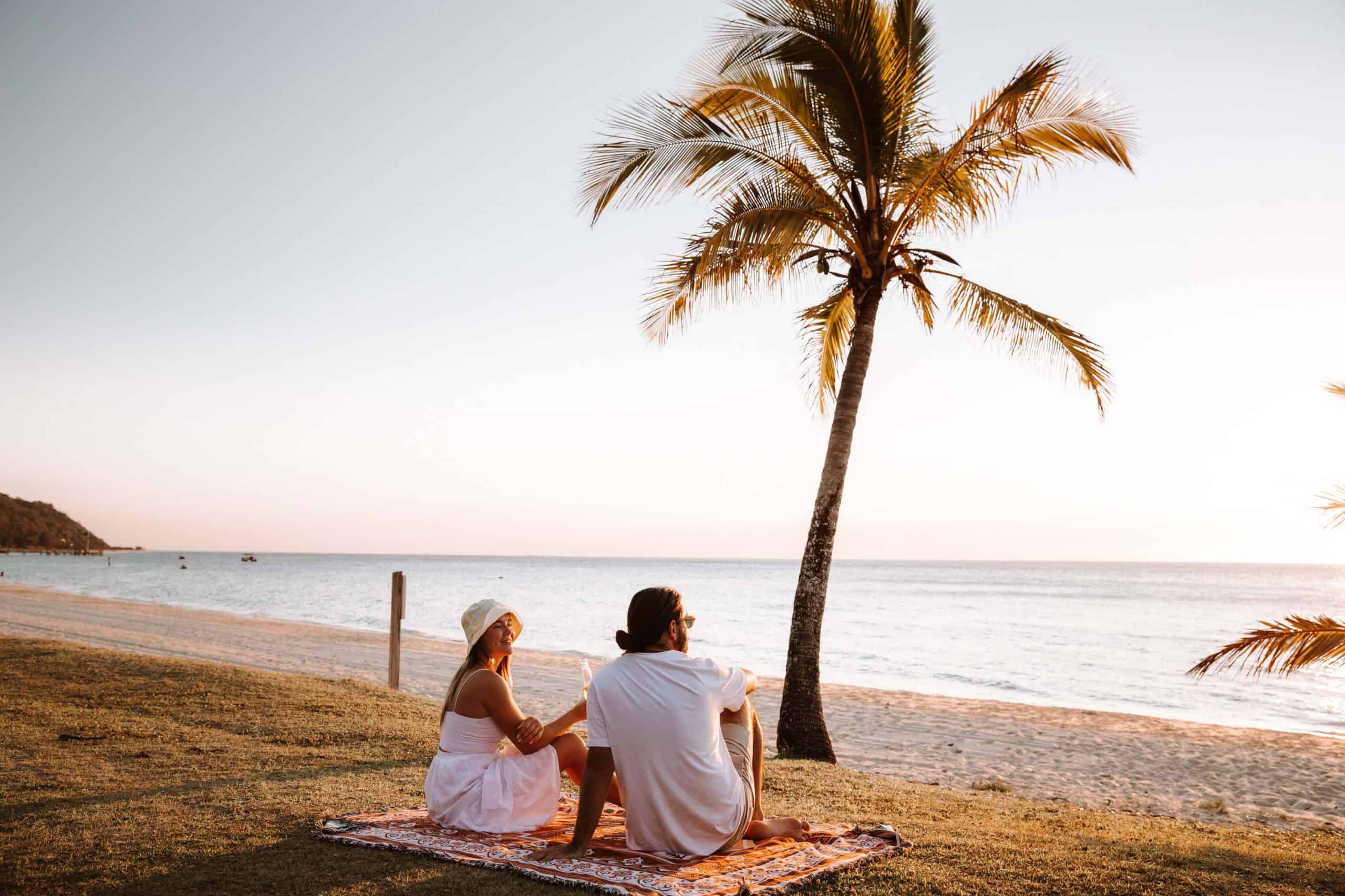 Tangalooma Resort, Moreton Island - couple sitting on the beach or seashore during sunset