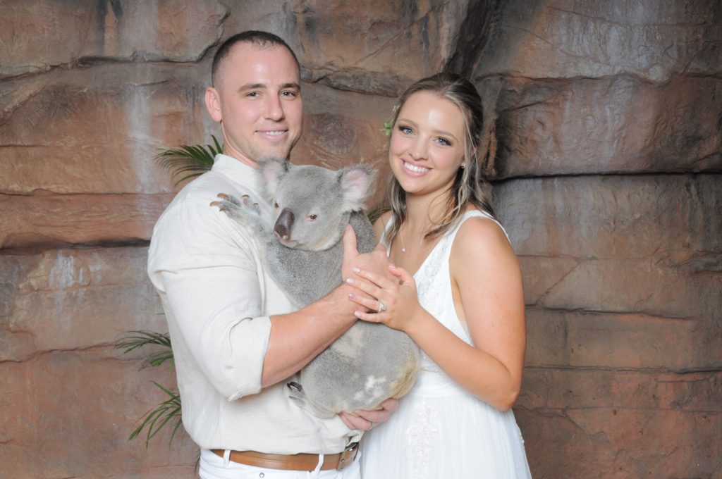 Australia-Zoo-wedding-venue-couple-newlyweds-bride-and-groom-portrait-holding-a-koala