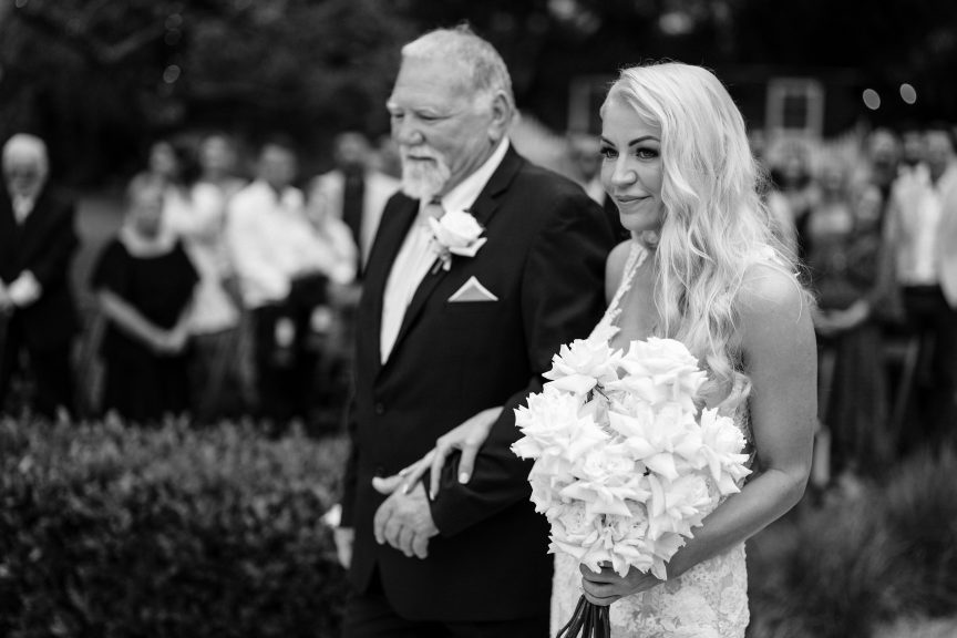 father of the bride walking the bride down the aisle during a wedding at Braeside Estate
